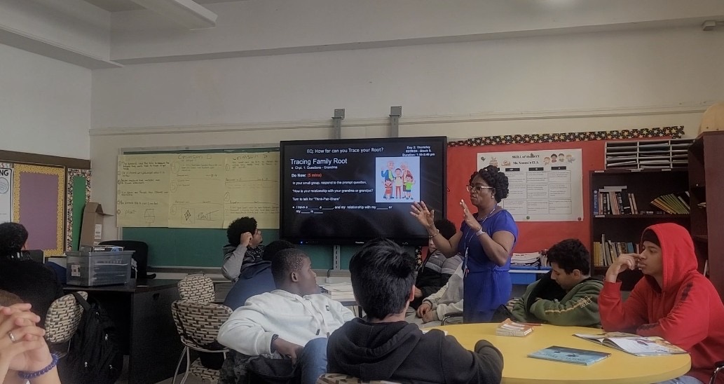 Collaborative classroom session with educators and multilingual learners engaged in structured literacy activities